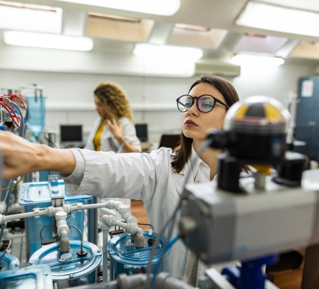 Two female lab employees at work.